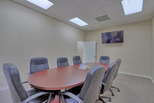 Modern conference room with large table at Bay Area Recovery Center - Pearland, an intensive outpatient program in Galveston.
