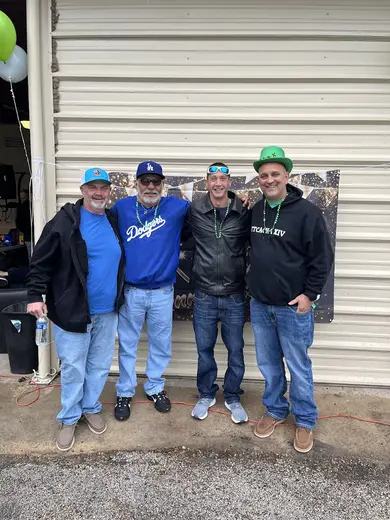 Group of men celebrating together at True Courage sober living home in Galveston.