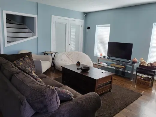 Cozy living room with plush seating at Riverside Recovery House, a sober living home in Galveston.