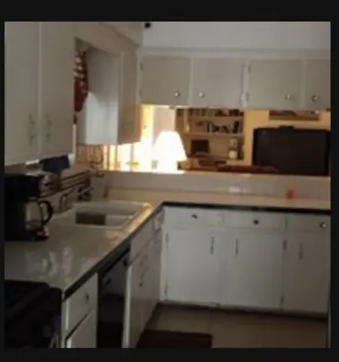 Bright kitchen with white cabinets at A New Freedom, sober living home in Galveston.