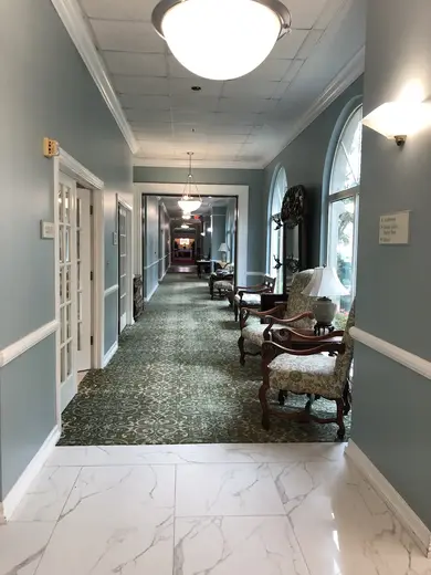 Spacious hallway with elegant seating at The Meridian treatment center in Galveston.